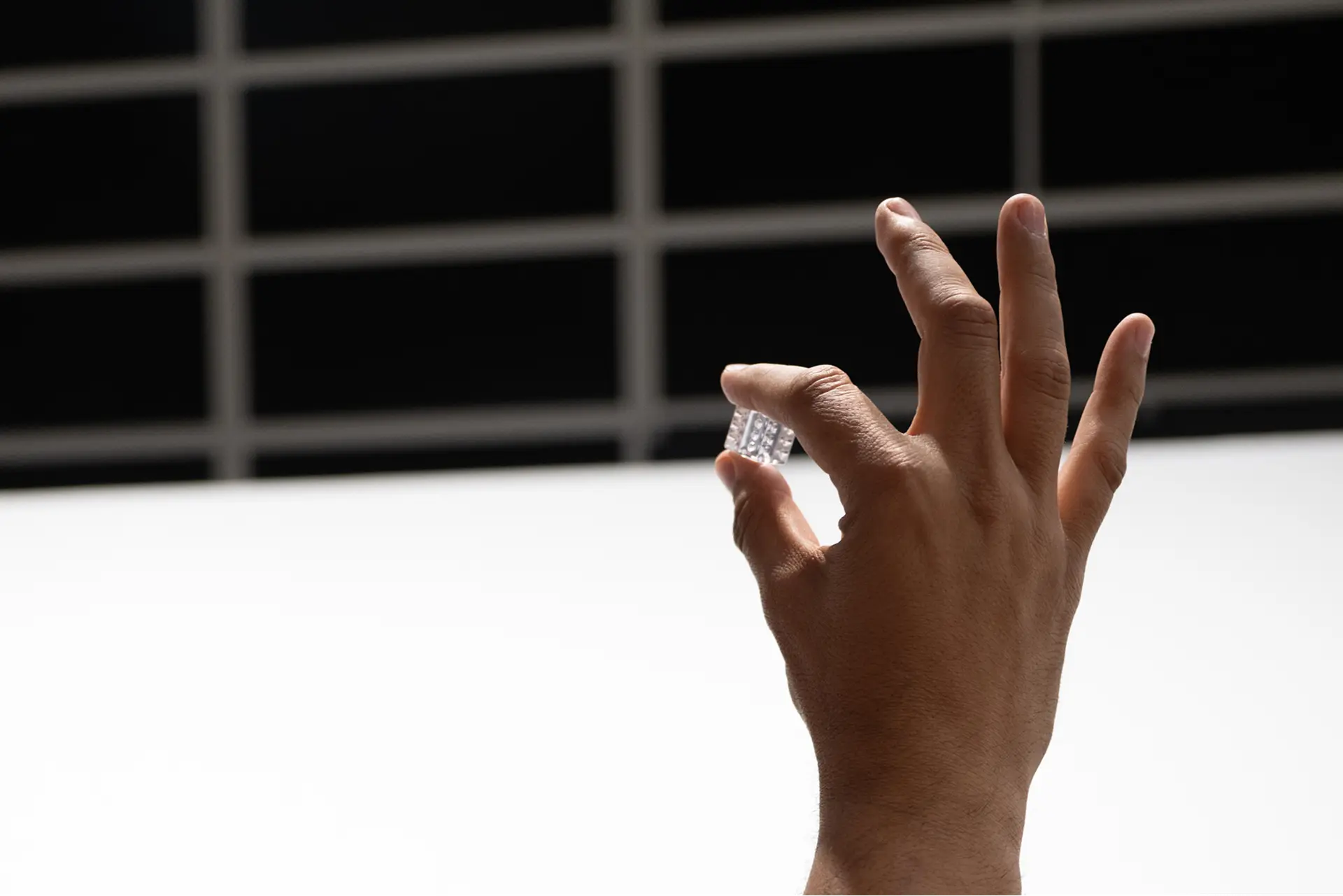 A resin die between finger and thumb